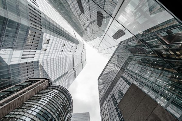 Vertical low angle shot of a modern business building scenery touching the sky A vertical low angle shot of a modern business building scenery touching the sky